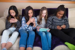 Group of kids on their mobile device