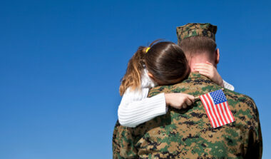 Military Father Hugging His Daughter With An American Flag