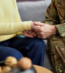 Veteran and Caregiver holding hands