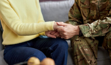 Veteran and Caregiver holding hands