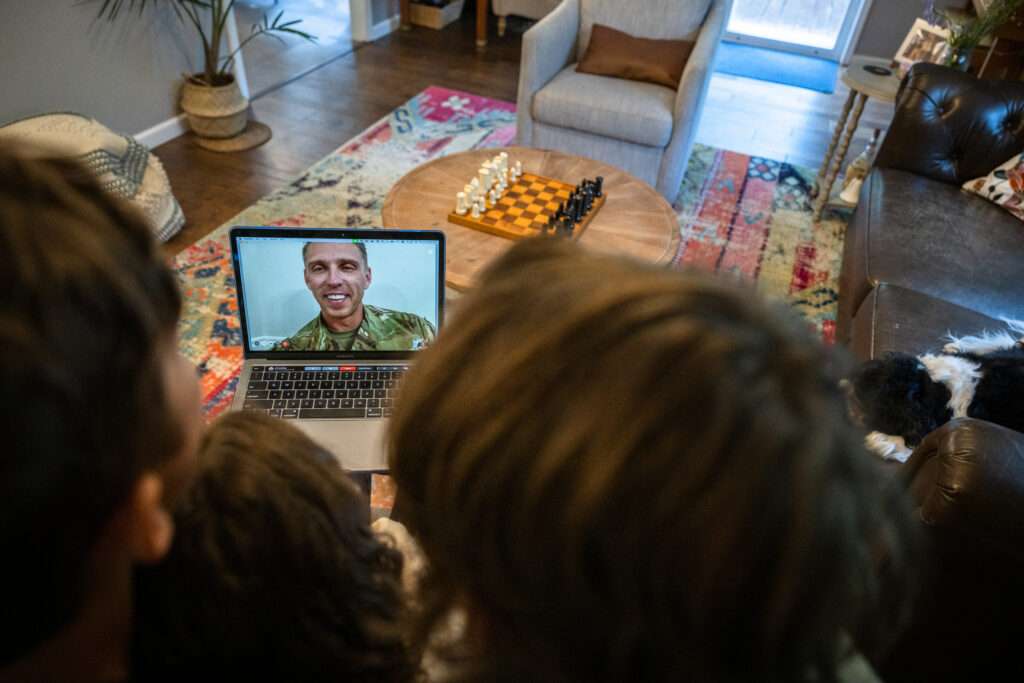 Air Force service member video chats with family during deployment.