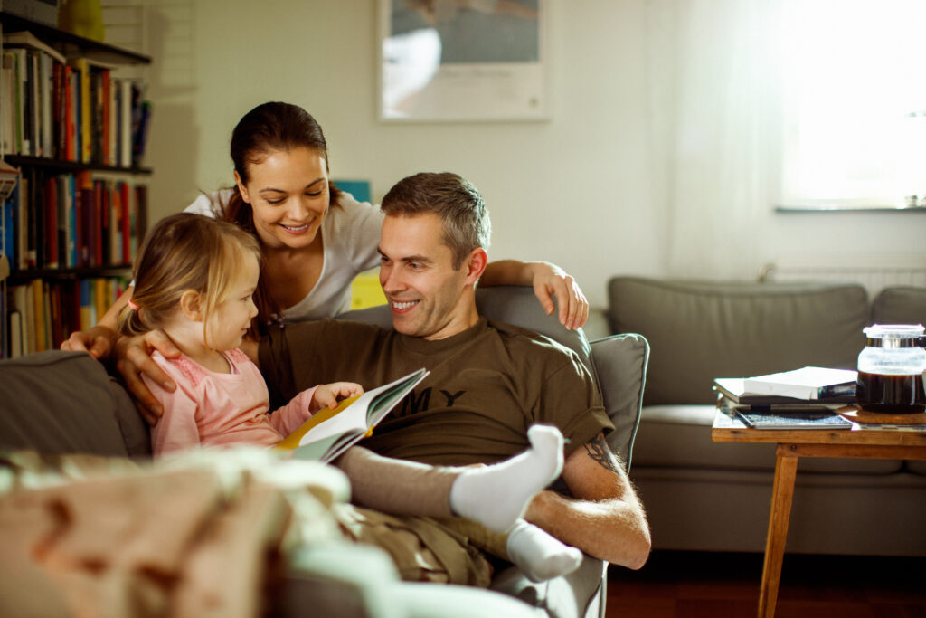 Father reuniting with his wife and daughter at home after deployment