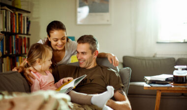 Father reuniting with his wife and daughter at home after deployment
