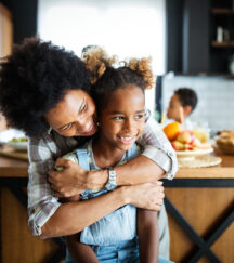 Military mom and daughter reintegration hug